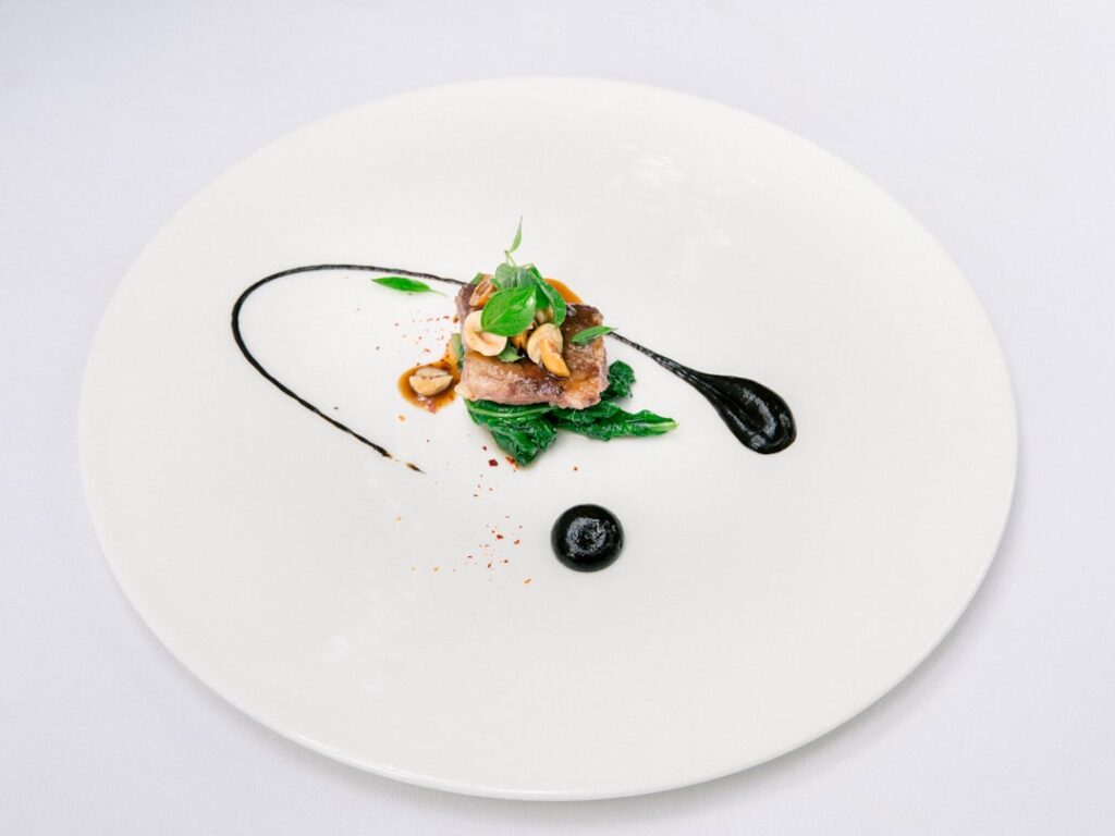 An artistically plated fine dining dish at Mozaic restaurant gastronomique in Bali, exemplifying the elevated cuisine associated with Michelin-starred restaurants.